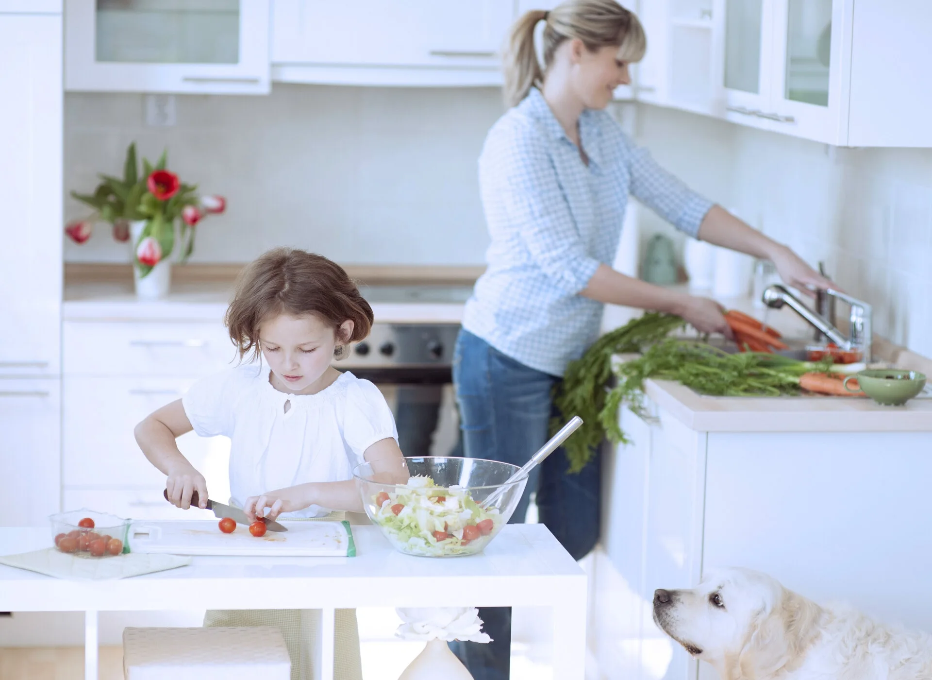 a woman and a child in a kitchen
