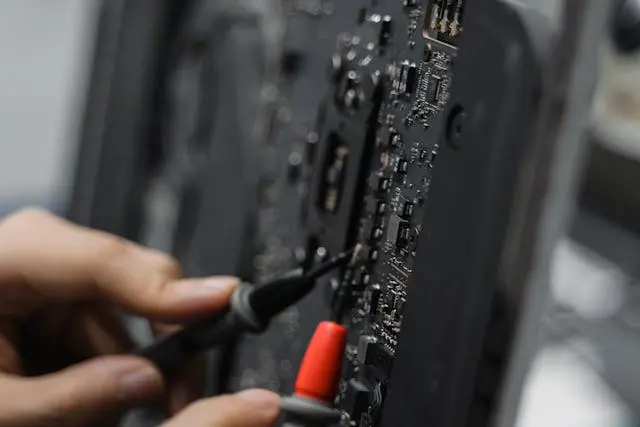hands repairing a motherboard