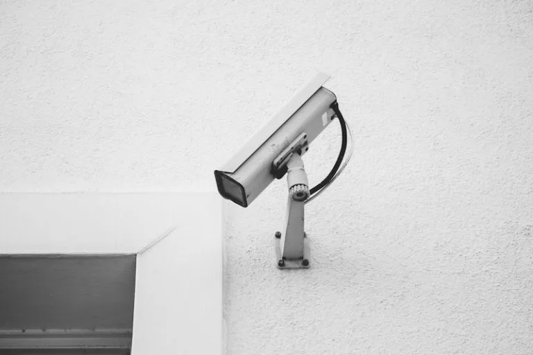 an old outdoor cctv camera mounted on a wall
